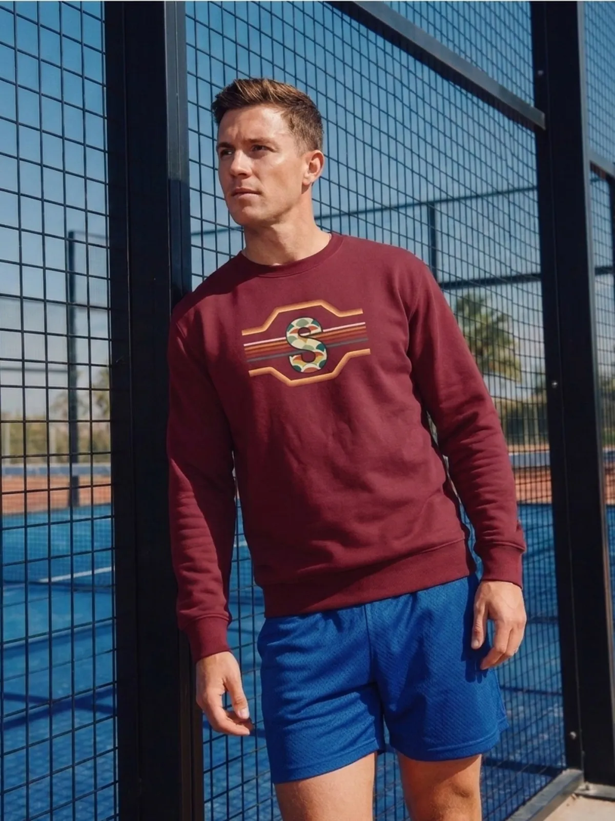 The same court with a man wearing the S crewneck