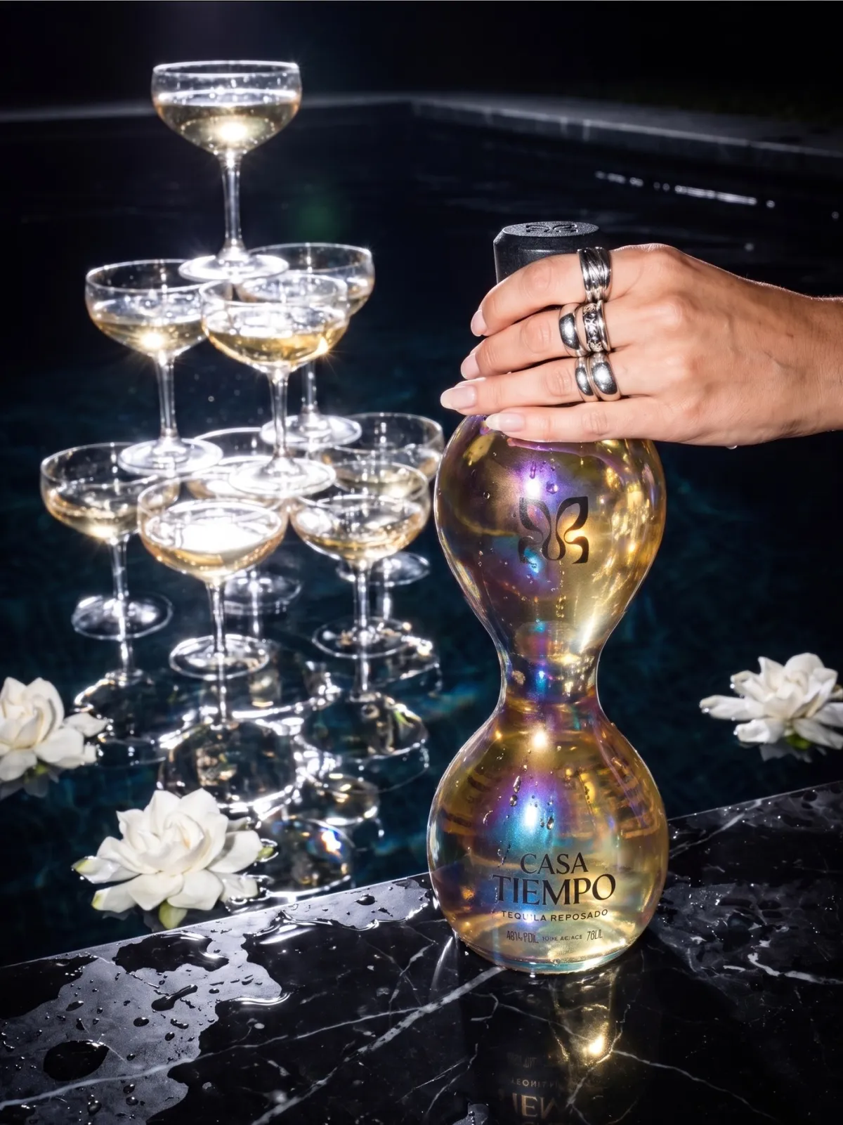 The same poolside shot with the iridescent reposado bottle